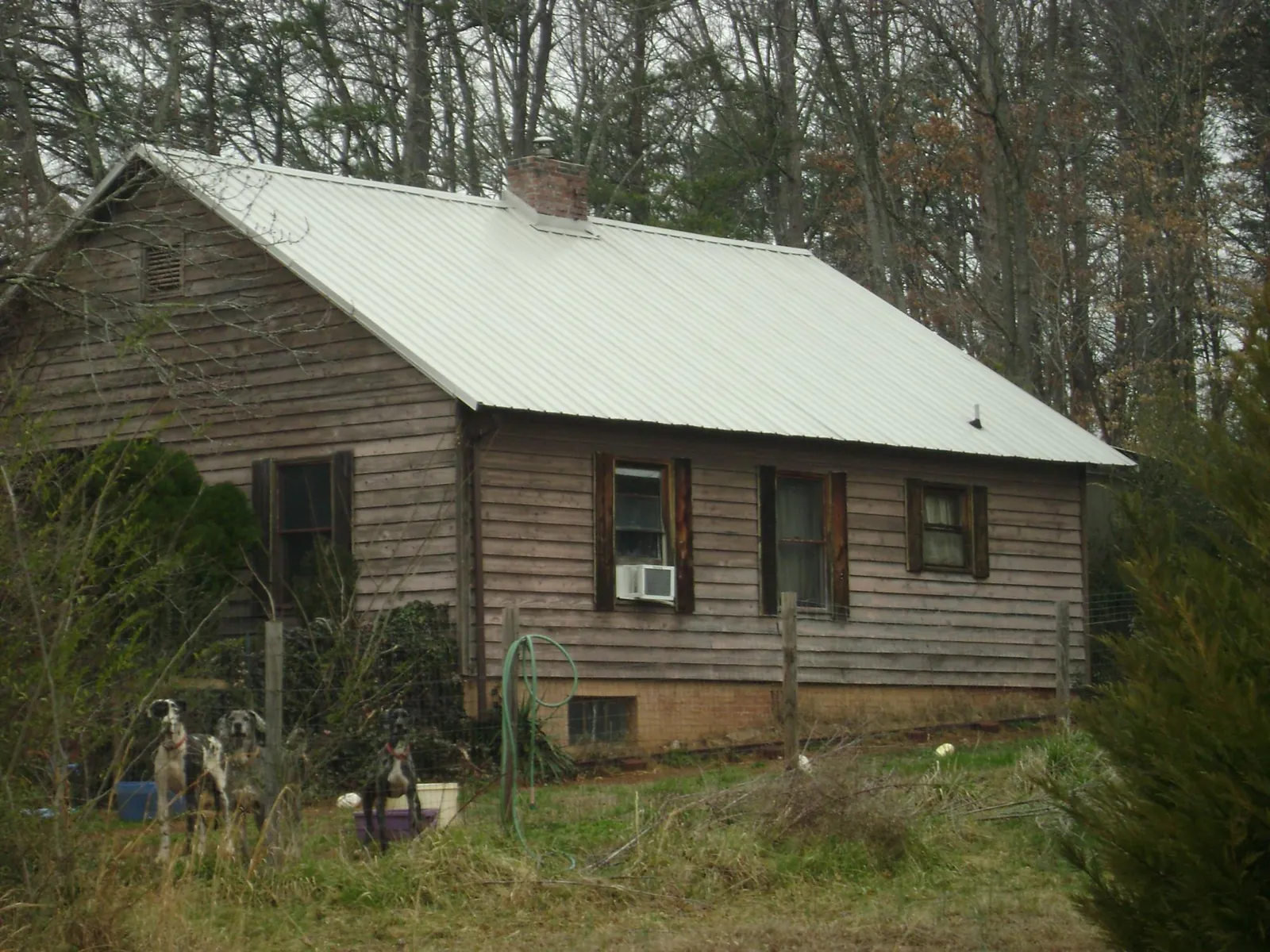 White metal roof on an old wood sided farmhouse, from a Metal Roof Installation job in Eastanollee